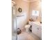 Bright bathroom with clear glass enclosed shower, vanity and toilet with a view of exterior foliage at 2157 Jeff St, North Charleston, SC 29405
