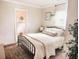 Bedroom featuring a wrought iron bed frame and stylish decor, adjoining bathroom can be seen at 2157 Jeff St, North Charleston, SC 29405