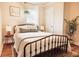 Cozy bedroom featuring a black metal bed frame, hardwood floors, and neutral decor for a relaxing ambiance at 2157 Jeff St, North Charleston, SC 29405