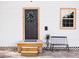 Inviting front entrance with a wooden door, a small porch with seating, and decorative accents at 2157 Jeff St, North Charleston, SC 29405