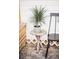 Close-up of a charming front porch, featuring a potted plant and bench next to the home's siding at 2157 Jeff St, North Charleston, SC 29405