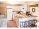 Modern kitchen and dining area featuring white cabinets, stainless appliances, and a breakfast bar at 2157 Jeff St, North Charleston, SC 29405
