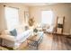 Inviting living room with cozy white sofa, rustic coffee table, and bright natural light at 2157 Jeff St, North Charleston, SC 29405