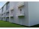 Modern apartment building featuring private balconies, white doors, and lush green lawn at 2161 W Jimtown Dr # 101, North Charleston, SC 29405