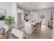 Open kitchen featuring an island with seating, stainless steel appliances, and light wood floors at 2161 W Jimtown Dr # 101, North Charleston, SC 29405