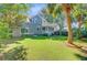 Lush backyard featuring mature trees and a well-manicured lawn, creating a private outdoor oasis at 2228 Daniel Island Dr, Charleston, SC 29492