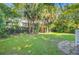 Lush backyard featuring mature trees and a well-manicured lawn, creating a private outdoor oasis at 2228 Daniel Island Dr, Charleston, SC 29492