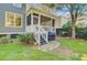 Well-maintained backyard with stairs leading to a porch, and a beautiful lush green yard at 2228 Daniel Island Dr, Charleston, SC 29492