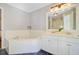 Well-lit bathroom boasts double sinks, a soaking tub, and a separate glass-enclosed shower at 2228 Daniel Island Dr, Charleston, SC 29492