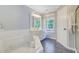 Bright bathroom featuring a soaking tub and a vanity with a window offering natural light at 2228 Daniel Island Dr, Charleston, SC 29492