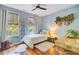 Well-lit bedroom with decor, hardwood floors, a ceiling fan, two windows, and a comfortable single bed at 2228 Daniel Island Dr, Charleston, SC 29492