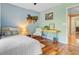 Cozy bedroom featuring hardwood floors, decor, a ceiling fan, and a comfortable single bed at 2228 Daniel Island Dr, Charleston, SC 29492