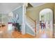 Inviting home entryway featuring hardwood floors, staircase, decorative arches, and a glimpse of the dining room at 2228 Daniel Island Dr, Charleston, SC 29492