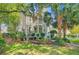 Lovely two-story home boasts a welcoming front porch, balcony, and meticulously maintained landscaping at 2228 Daniel Island Dr, Charleston, SC 29492