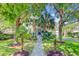 Inviting home exterior showcases palm trees, lush landscaping, and a walkway leading to the front door at 2228 Daniel Island Dr, Charleston, SC 29492