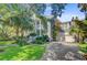 Charming two-story home with a well-manicured lawn, lush landscaping, and a two-car garage at 2228 Daniel Island Dr, Charleston, SC 29492
