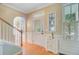 Bright foyer with hardwood floors, staircase, and classic architectural details, leads to the rest of the home at 2228 Daniel Island Dr, Charleston, SC 29492