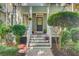 Inviting front porch features a cozy seating area and decorative plants, showcasing the home's curb appeal at 2228 Daniel Island Dr, Charleston, SC 29492