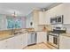 Galley kitchen equipped with stainless appliances, granite counters, and white cabinets at 2228 Daniel Island Dr, Charleston, SC 29492