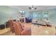Cozy living room features a fireplace, comfortable seating, and an abundance of natural light from large windows at 2228 Daniel Island Dr, Charleston, SC 29492