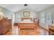 Tranquil bedroom with vaulted ceilings, shutters, wood furniture, and wood floors at 2228 Daniel Island Dr, Charleston, SC 29492