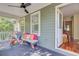 Relaxing porch with an outdoor ceiling fan, a bench with bright pillows, and a wicker chair at 2228 Daniel Island Dr, Charleston, SC 29492