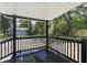 This back porch has a white ceiling and dark painted posts and railing at 227 Grace St, Walterboro, SC 29488