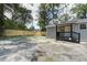 The backyard features a wood privacy fence, back porch, and newly planted yard at 227 Grace St, Walterboro, SC 29488