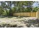 Backyard featuring a new wooden fence, freshly seeded yard and view of wooded area at 227 Grace St, Walterboro, SC 29488