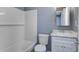 A well-lit bathroom featuring white tiled shower and tub with a white vanity and sink at 227 Grace St, Walterboro, SC 29488