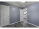 A gray bedroom showcases a doorway leading into the kitchen, offering a glimpse of the home's layout at 227 Grace St, Walterboro, SC 29488