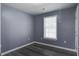 Bright bedroom with a large window offering ample natural light and gray flooring at 227 Grace St, Walterboro, SC 29488