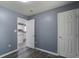 A gray bedroom showcasing a doorway leading into the kitchen, offering a glimpse of the home's layout at 227 Grace St, Walterboro, SC 29488
