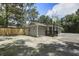 Newly renovated home with gray siding and a freshly planted front yard and a wooden fence at 227 Grace St, Walterboro, SC 29488