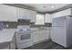 Efficient kitchen with white cabinets, stainless sink, and stove, providing a practical cooking space at 227 Grace St, Walterboro, SC 29488