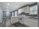 Bright kitchen features white cabinets, stainless steel appliances, and an open floor plan at 227 Grace St, Walterboro, SC 29488