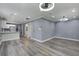 Open-concept layout featuring living room with kitchen, gray walls, modern light fixtures and vinyl flooring at 227 Grace St, Walterboro, SC 29488