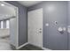 This mudroom features gray walls, tile floors, and the door to the backyard at 227 Grace St, Walterboro, SC 29488