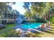 Inviting backyard with a sparkling pool, hot tub, lush greenery, and comfortable lounge chairs at 2514 Myrtle Ave, Sullivans Island, SC 29482