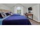 A bright bedroom featuring three beds, a vaulted ceiling, wood floors, a workspace and a large window at 2514 Myrtle Ave, Sullivans Island, SC 29482