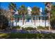 Charming home with a inviting wrap around porch and lush landscaping at 2514 Myrtle Ave, Sullivans Island, SC 29482