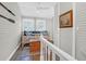 A cozy living space with a daybed, wood floors, white ceiling fan, and decoratively painted oars at 2514 Myrtle Ave, Sullivans Island, SC 29482