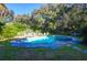 Beautiful pool with stone patio, lounge chairs, and lush landscaping, perfect for outdoor relaxation and recreation at 2514 Myrtle Ave, Sullivans Island, SC 29482