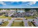 Aerial view showcasing the community clubhouse, manicured lawns, and neatly arranged parking at 274 Tupelo Lake Dr, Summerville, SC 29486