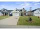 Inviting home with a wide driveway, tidy lawn, covered porch, and attractive exterior details at 274 Tupelo Lake Dr, Summerville, SC 29486