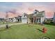 Attractive home with a well-maintained lawn, covered front porch, long driveway, and classic design at 274 Tupelo Lake Dr, Summerville, SC 29486