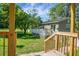 Inviting back deck with wooden railing and lush green lawn at 286 Mallard Lake Rd, Dorchester, SC 29437