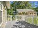 Inviting back deck featuring a pergola, white railings, and views of the house and lush greenery at 286 Mallard Lake Rd, Dorchester, SC 29437