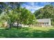Large backyard featuring a deck, porch, mature trees, and a tranquil outdoor setting at 286 Mallard Lake Rd, Dorchester, SC 29437