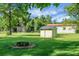Spacious backyard with a fire pit and storage building, ideal for outdoor enjoyment at 286 Mallard Lake Rd, Dorchester, SC 29437